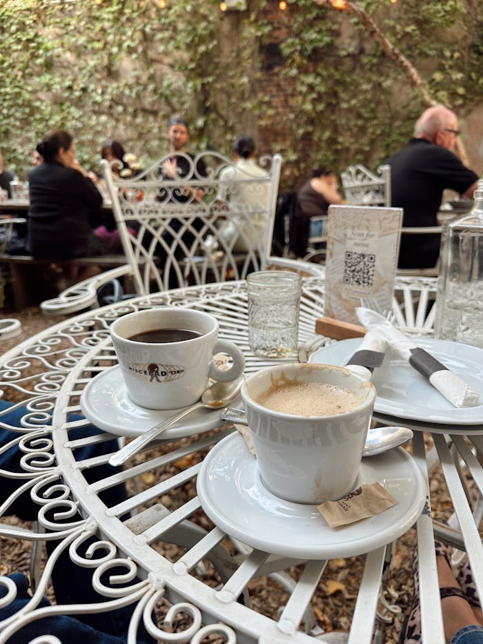 Enjoy cups of coffee in a charming outdoor New York cafe setting.